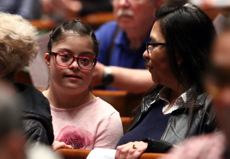 Mother and daughter with down syndrome in pew